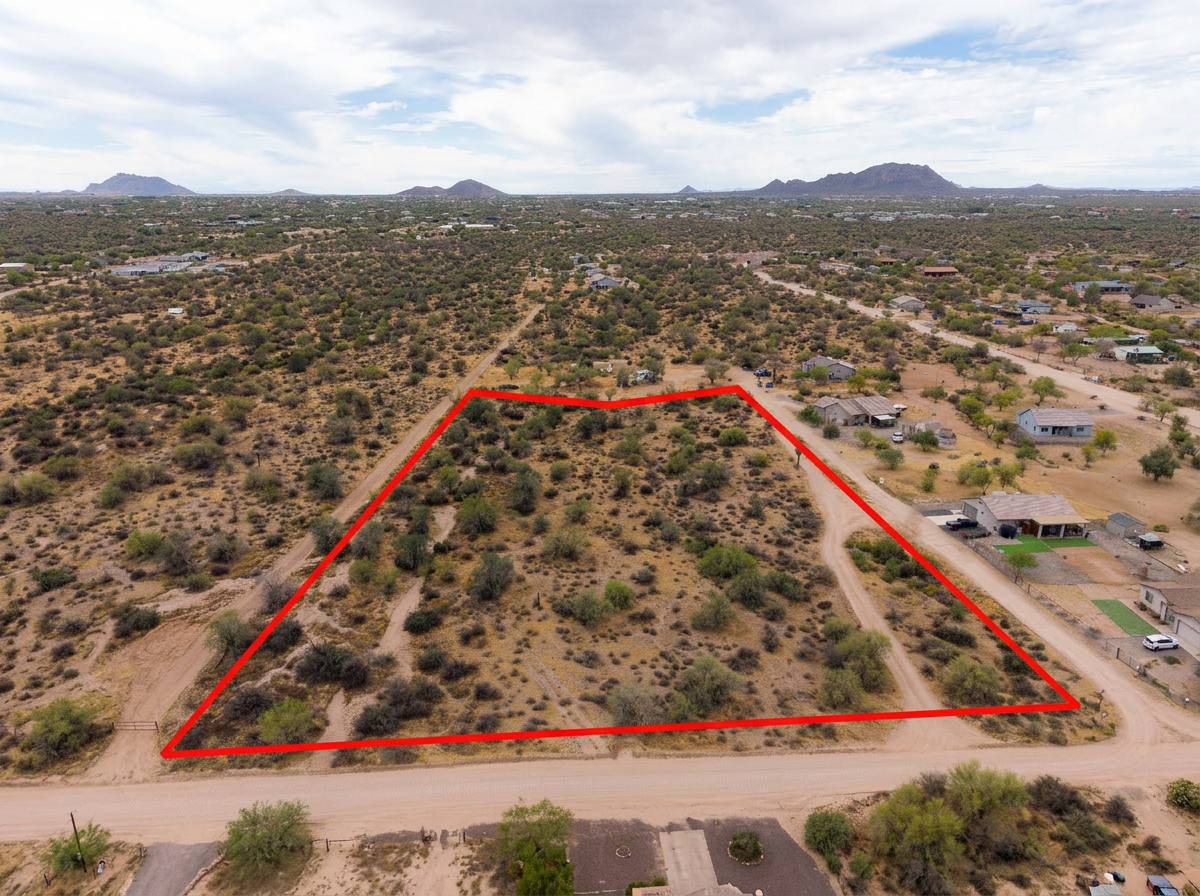 Aerial drone photo of an Arizona desert parcel with red boundary lines outlining the property